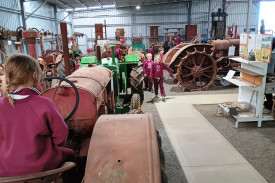 School students inspecting tractors.