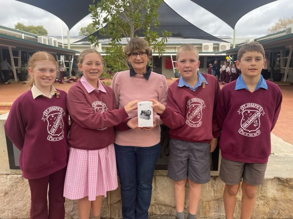 Heather Prout (centre) with St Joseph’s School students with their new microphone set.