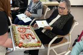 Fruitcake was passed around to eager residents after the cake cutting.