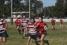 There was a bit of father/daughter rivalry in the Flamin’ Galahs verses Old Boys tri tag game, with Rowen Chandler pictured chasing down daughter Sarah.