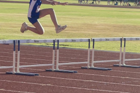 Regan Godber clears a hurdle at the regional championships at Dubbo.