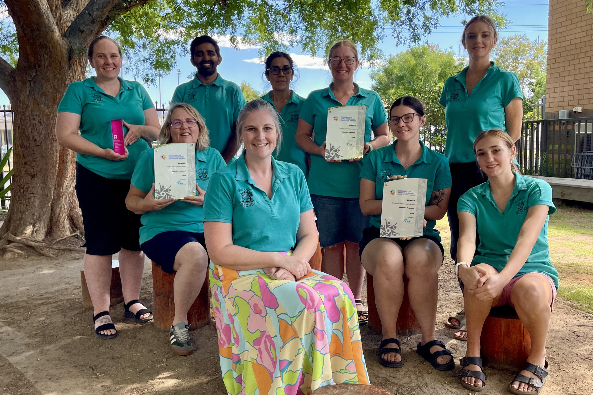The Gilgandra Preschool team back at Gilgandra with the various awards (Reimagine National Award and Excellence in Early Childhood Education Awards). Standing left to right: Kristy Hyndes, Kalpa Bhagya, Carolina Franks, Rebecca Sandry, Lindy Burrell and sitting left to right: Amber Bunter, Jessica Turnbull, Hannah Harland, and Najarra Naden. Photo supplied.