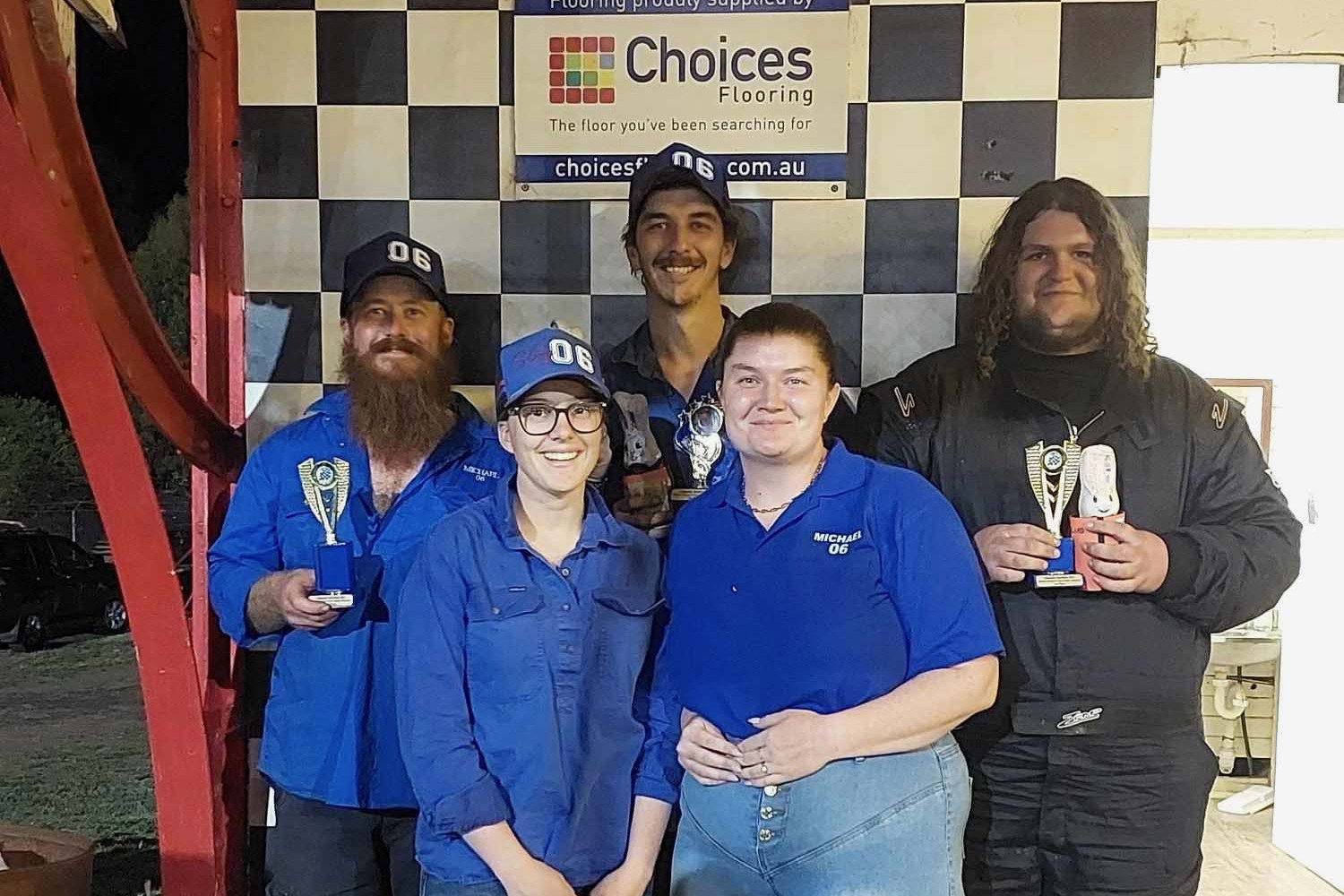 Back, from left: Richard Howard (second place), winner Nathan Harland (Michael’s son) and Braydon Holland (third) and front, from left Michael Harland’s daughters Makayla and Shaliana Harland after the Michael Harland Memorial Race at the Good Friday Speedway meeting. Photo: Supplied.