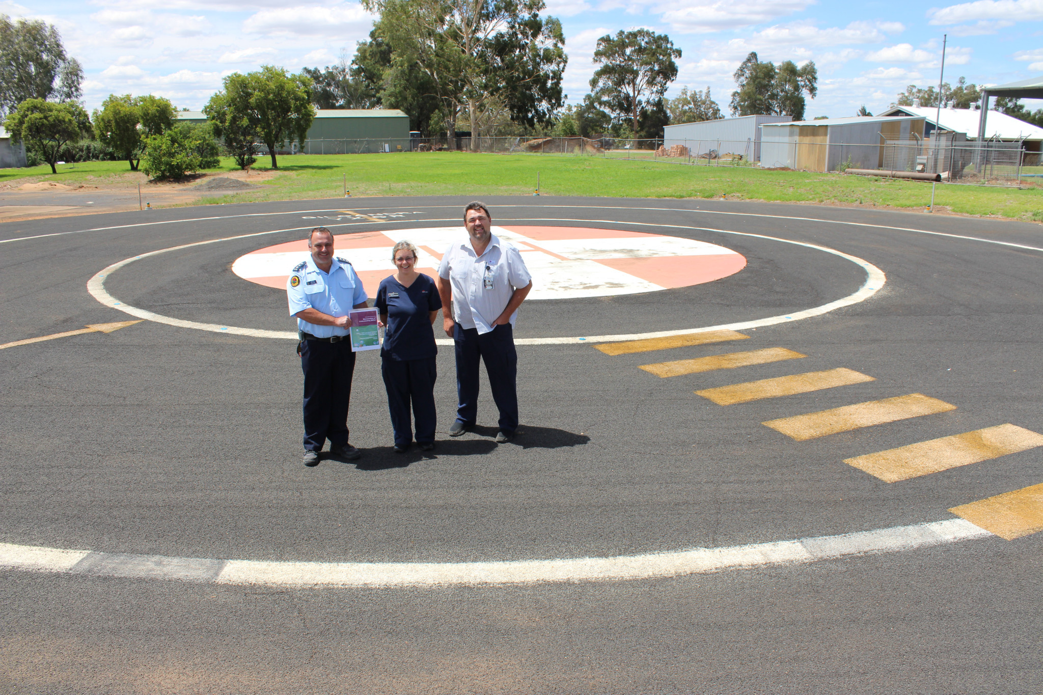 Gilgandra State Emergency Service’s unit commander Chris Riley with the MOU document and NSW Health’s Tanya Hutchison and John Alchin.