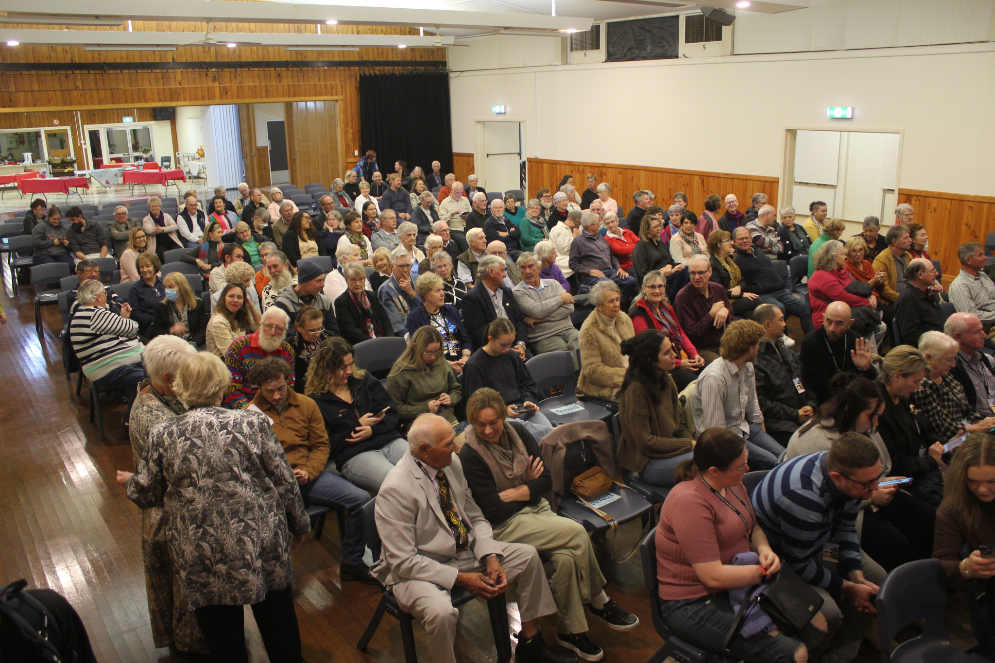 An eager crowd gathered quickly in the Gilgandra Shire Hall once the doors were opened. Within minutes, most of the rows had been filled, with more of the audience still to come.