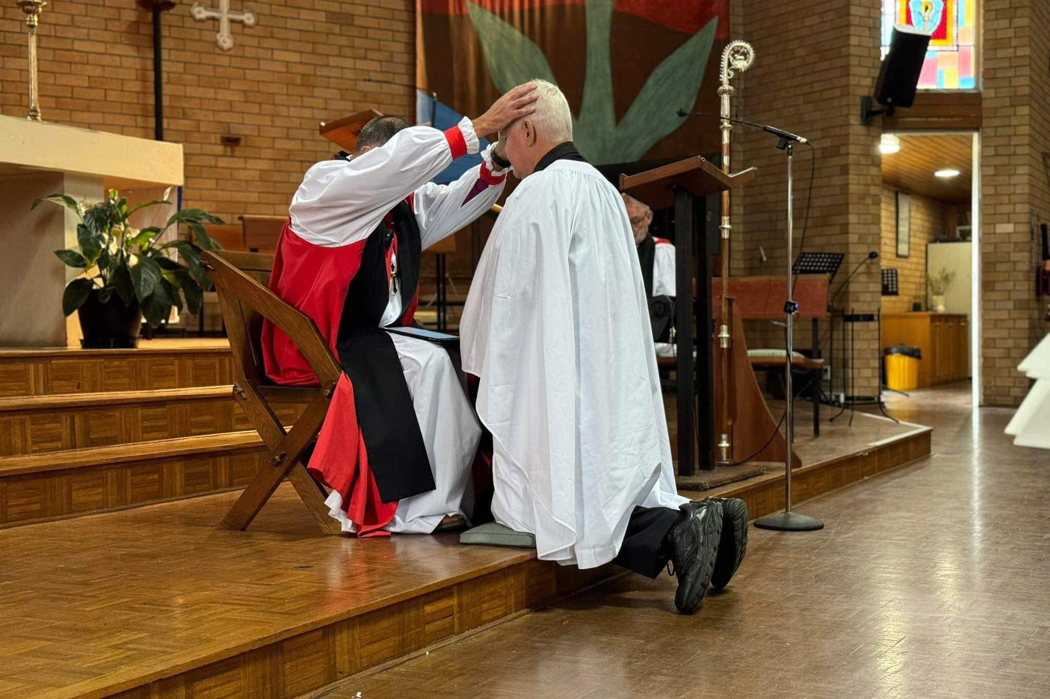 Anglican bishop Mark Calder ordaines Stuart Border as a deacon.