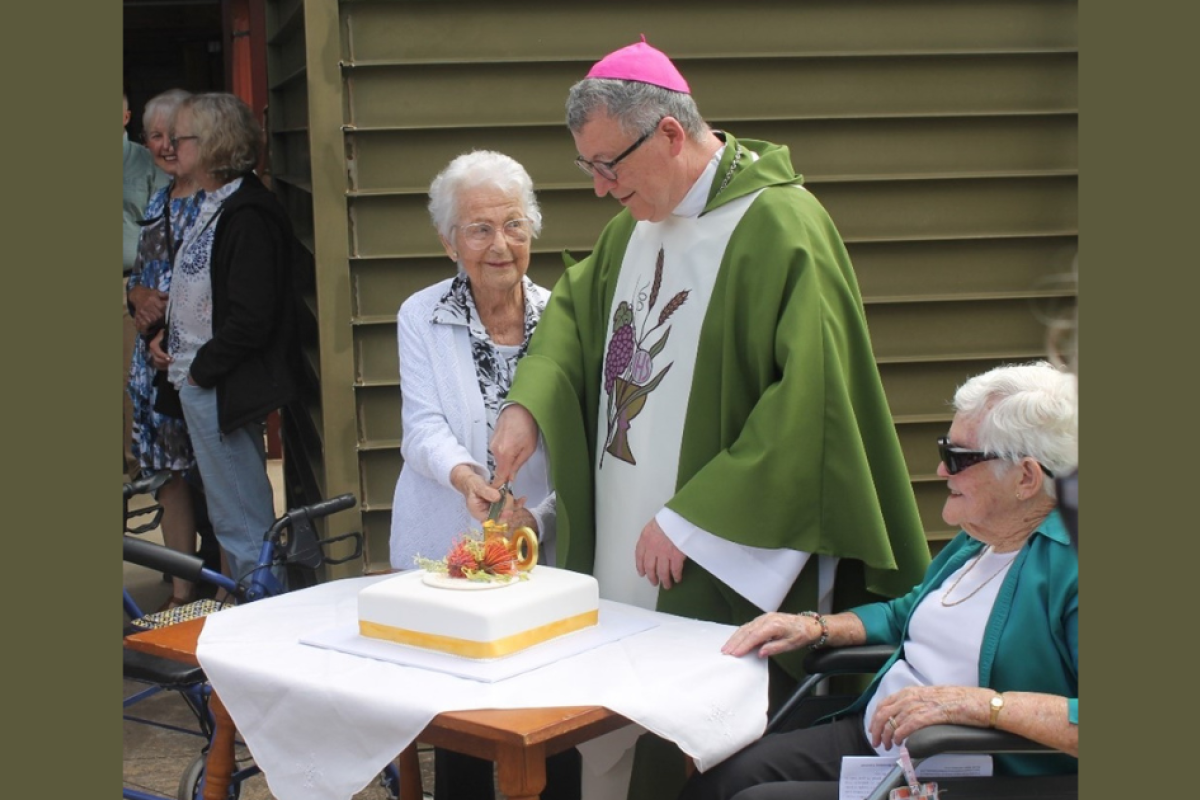 Cutting of the cake by Bishop Michael McKenna and parishioners Gwen Whiteman and Ilva Horan. Photos supplied.