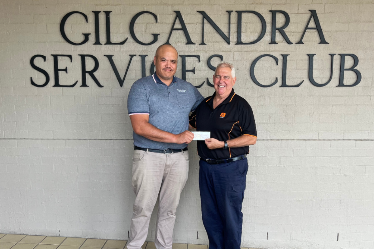 Gilgandra Services Club manager Quentin Karaitiana presenting a cheque from the club to Stuart Border, from the St Ambrose Memorial Church Restoration Committee, for $1860, raised from the 2025 Australia Day Prelude Concert in January.