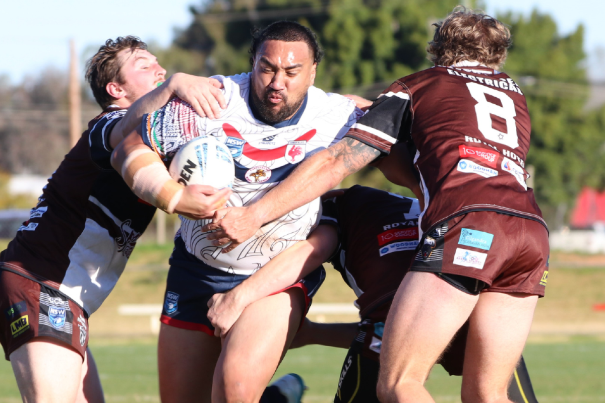 The Ahrens Gilgandra Panthers look to stop Cobar's Gerald Mackey. Photos courtesy of The Cobar Weekly.