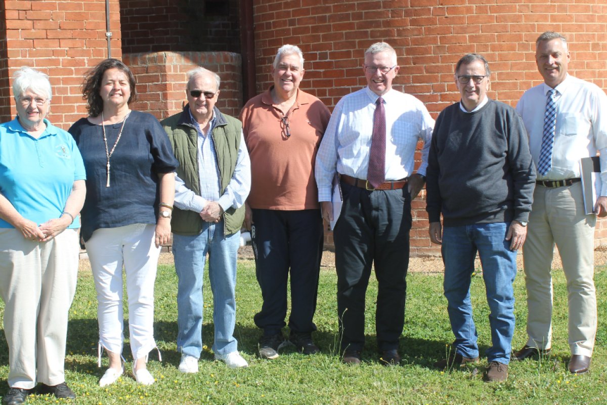 Margo Piggott, Cr Madeline Foran, Doug Clouten, Stuart Border, member for Parkes Mark Coulton, mayor Doug Batten, and candidate for Parkes Jamie Chaffey stand in front of St Ambrose Memorial Church. Photo by The Gilgandra Weekly: Nicholas Croker.