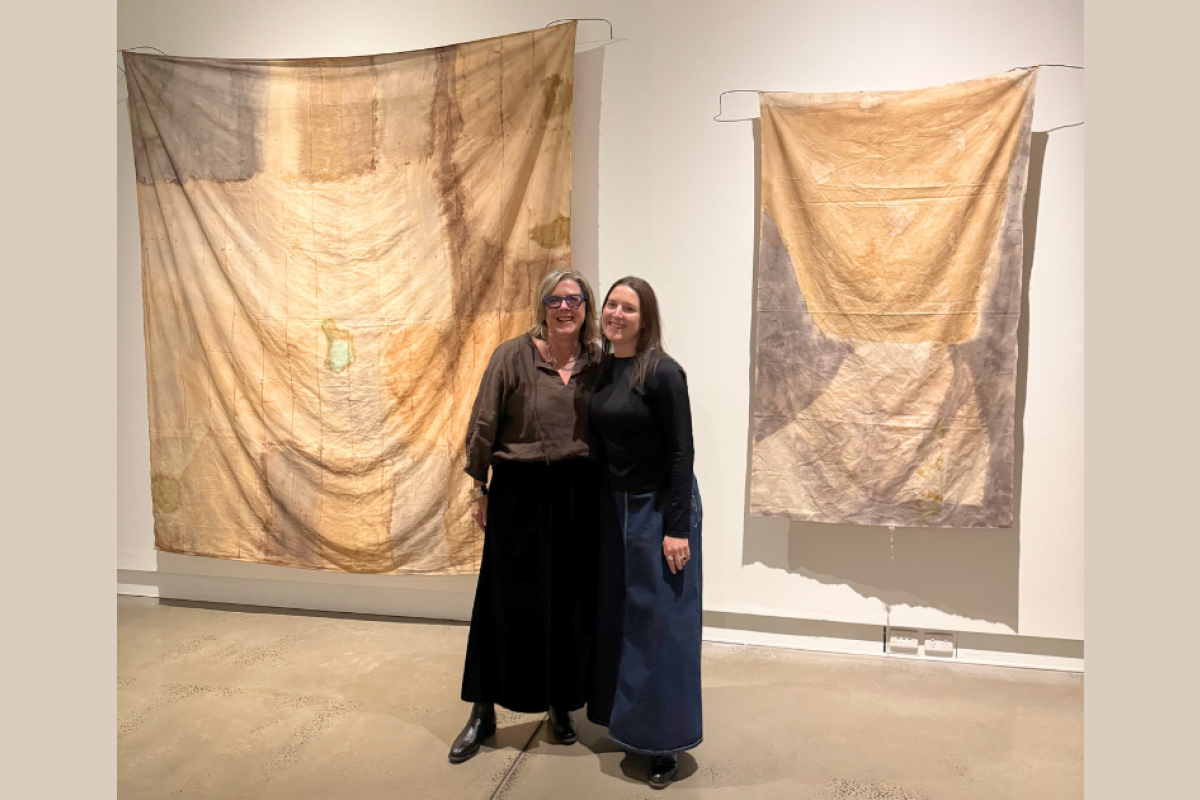 Proud mum, Elizabeth McAllister with Gilgandra artist Clementine Belle McIntosh with her artworks at the Western Plains Cultural Centre. Photo: supplied.