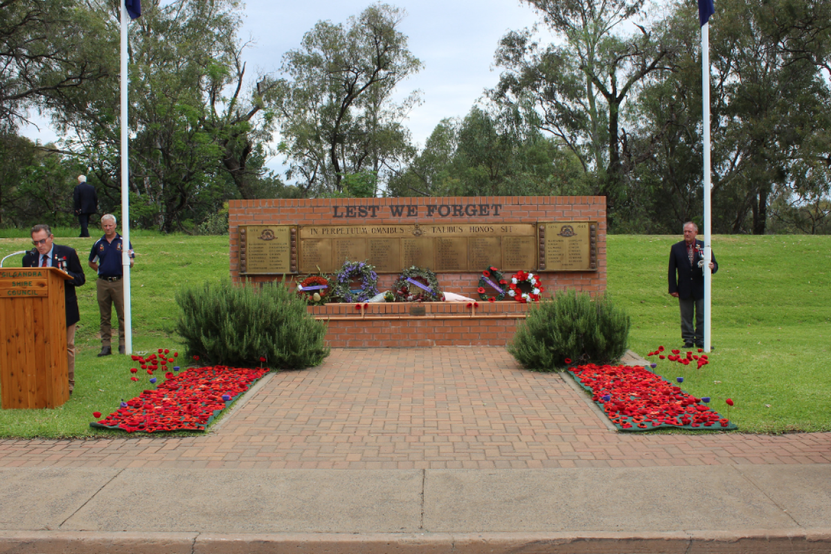 Gilgandra RSL Sub-Branch president Bruce Horwood gave the opening address on Remembrance Day. Supported by David Makila and William Ballard on the flag poles. Photos by The Gilgandra Weekly: Lucie Peart.