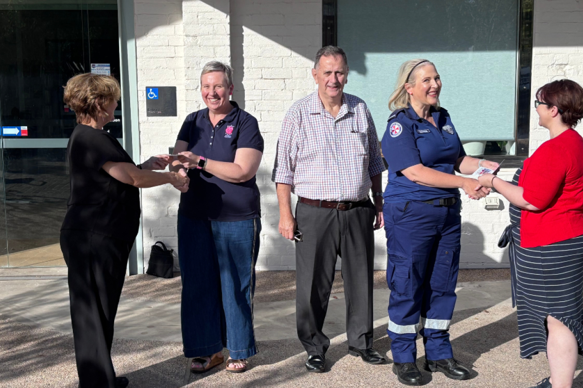 Representatives from University of Newcastle and Gilgandra Shire Council presenting winners of the Youth Strategy Survey - (centre) Eliza Mudford (accepted by Natalie Mudford) and Rebecca Medd, - a Coo-ee Cash Card prize. Photo by The Gilgandra Weekly: Lucie Peart.