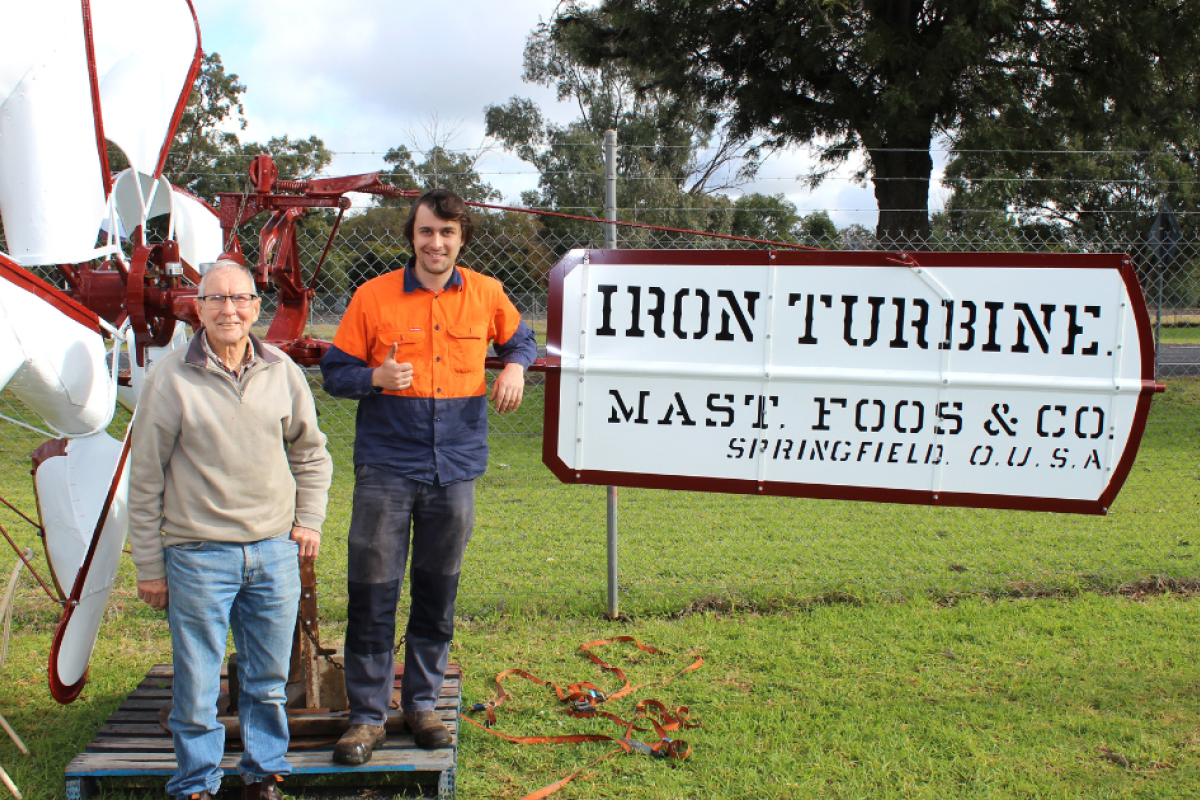 Gilgandra Museum president Phil Howard with windmill restorer Thomas Glastonbury just prior to the rare iron turbine being lifted back proudly on display at the front of the museum last Friday, June 21, 2024. Photo by The Gilgandra Weekly: Lucie Peart.