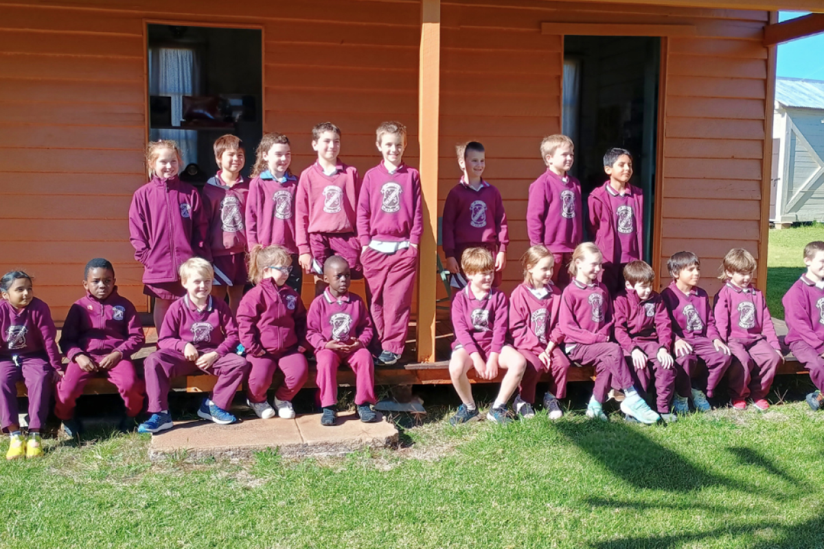 School students on the verandah of the Berida Bookkeeper’s Hut.