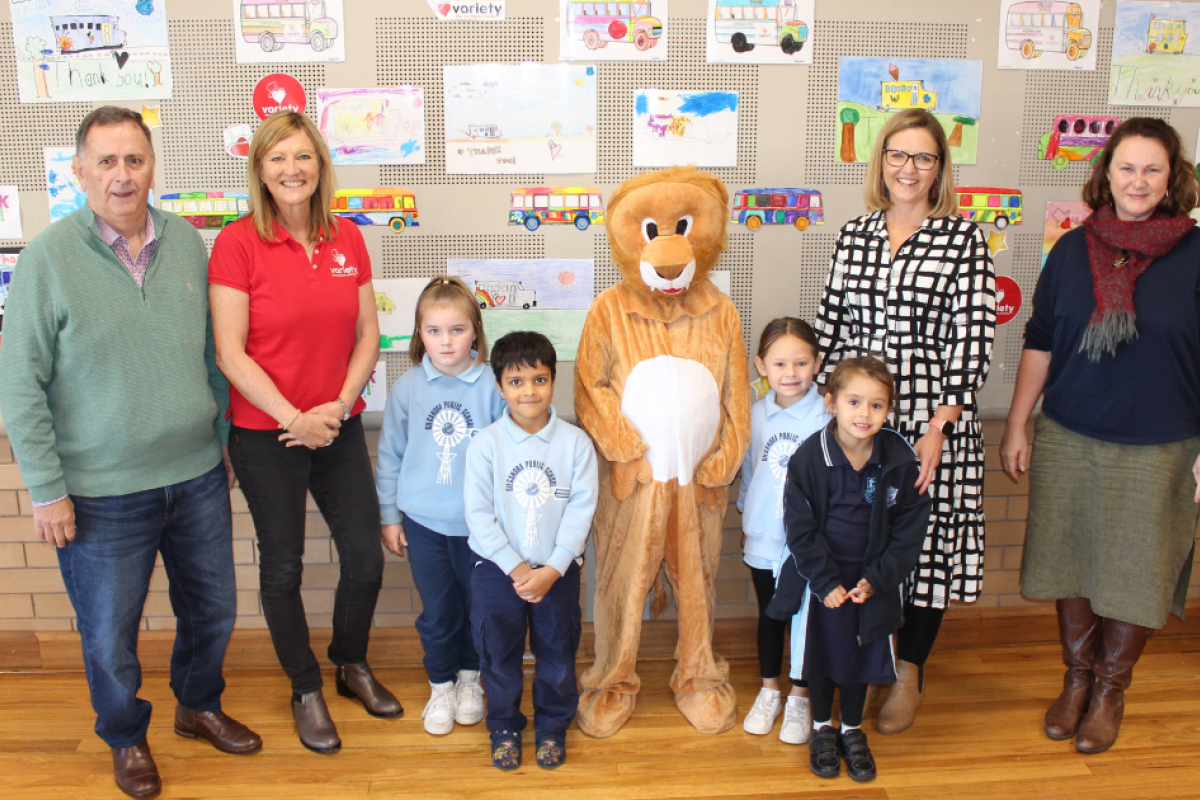 Gilgandra Shire Council mayor Doug Batten with Variety’s Liz Gearing, Gilgandra Public School’s mascot with kindergarten students, deputy principal Rebecca Rogers and teacher Catherine Dunn at last week’s special celebration for the Variety-donated Sunshine Coach. Photo by The Gilgandra Weekly: Lucie Peart.