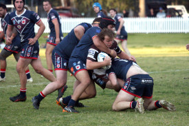 Ahrens Gilgandra Panthers player Kenny Johnson being held up by a few of the Cobar Roosters during Saturday’s match. Photos by Stephen Basham.